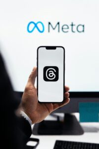 Gracias Agencias 7 Una persona sostiene un smartphone con el logotipo de la aplicación Threads frente a la pantalla de un ordenador con el logotipo de Meta.
