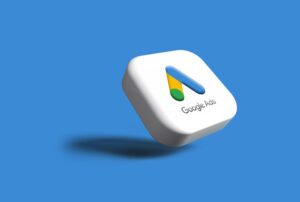 Botón cuadrado en 3D con el logotipo de Google Ads y el texto "Google Ads" sobre fondo azul, proyectando una sombra.