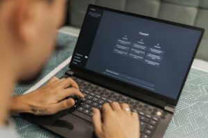 Una persona teclea en un ordenador portátil que muestra la interfaz ChatGPT en la pantalla.