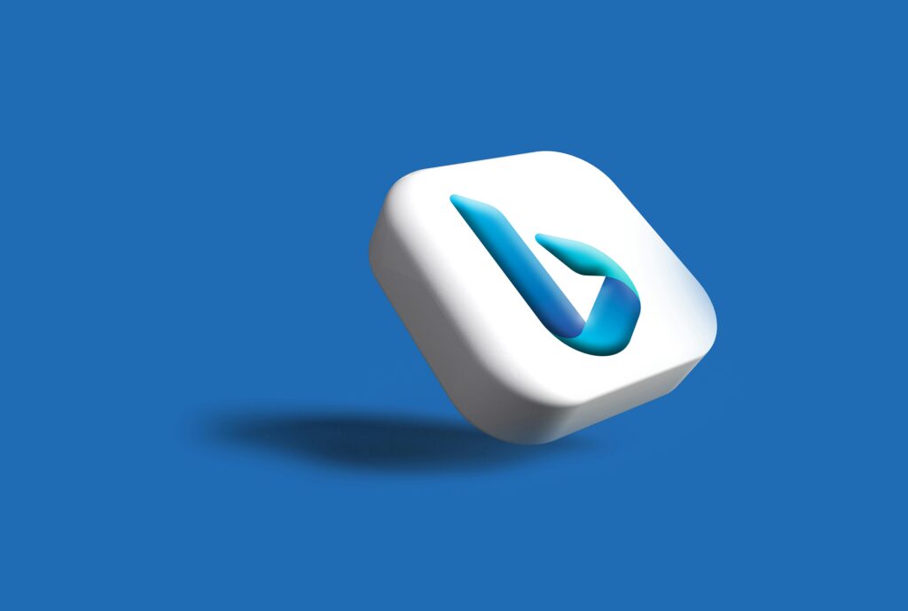 Icono del logotipo de Bing en 3D sobre fondo azul, con el icono proyectando una sombra a la izquierda.